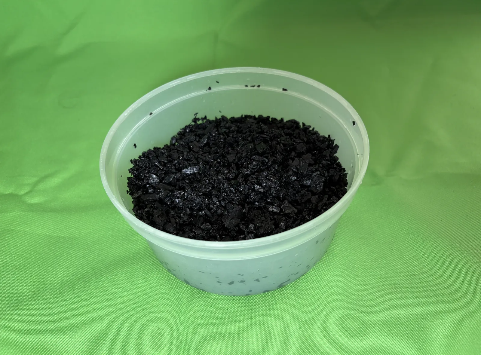 Tub of wet, washed charcoal granules