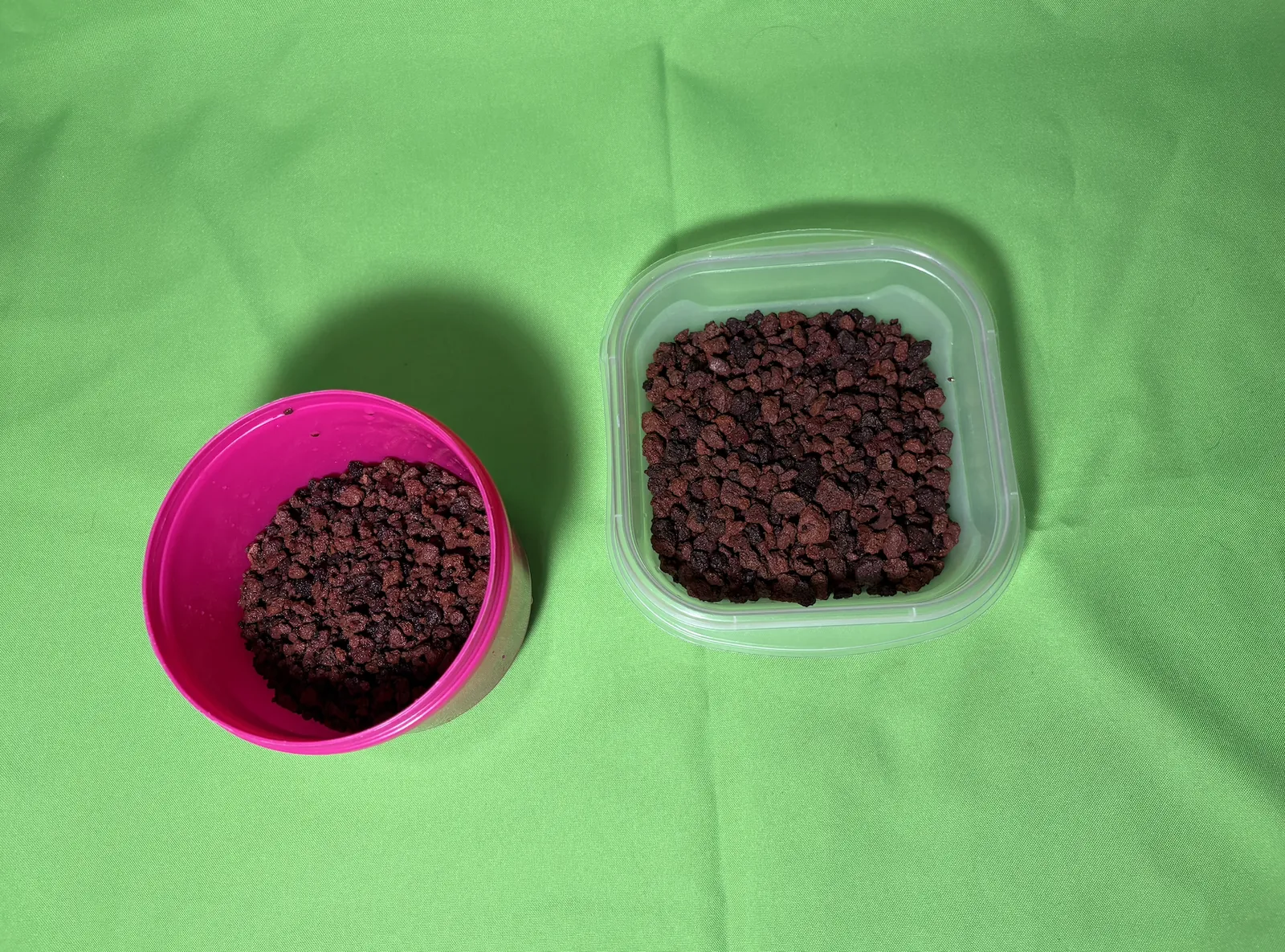 Two containers of red volcanic scoria, one finer than the other